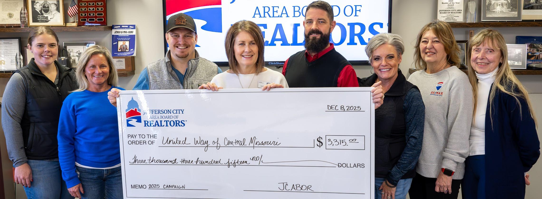 Check presentation to United Way; Proceeds from 5K Run/Walk